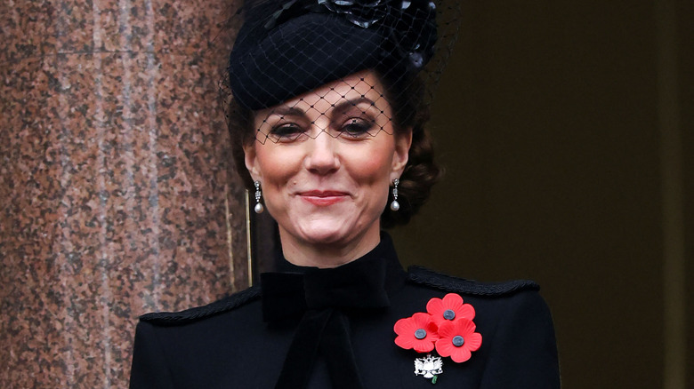 Kate Middleton smiling in an all-black outfit