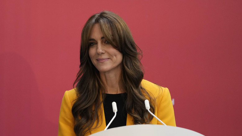 Kate Middleton speaking in yellow blazer