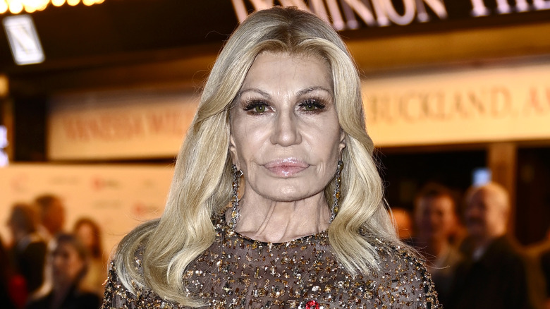 Donatella Versace looking stern in a sparkly top