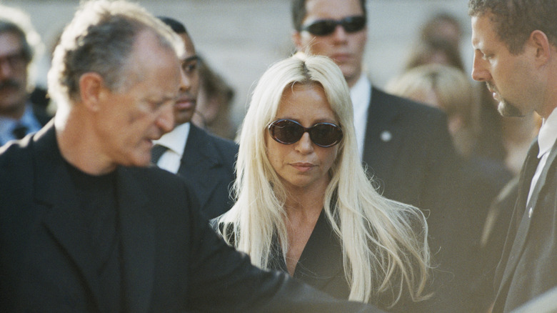 Donatella Versace wearing dark glasses and a black outfit