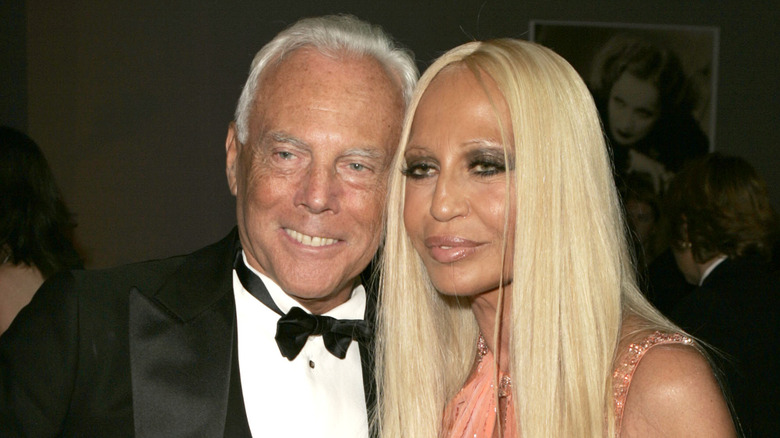 Giorgio Armani and Donatella Versace smiling for a photo