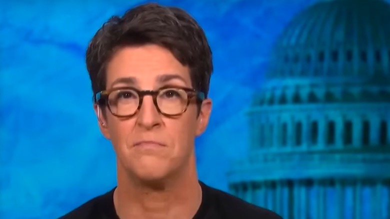 Rachel Maddow behind the anchor desk on MSNBC