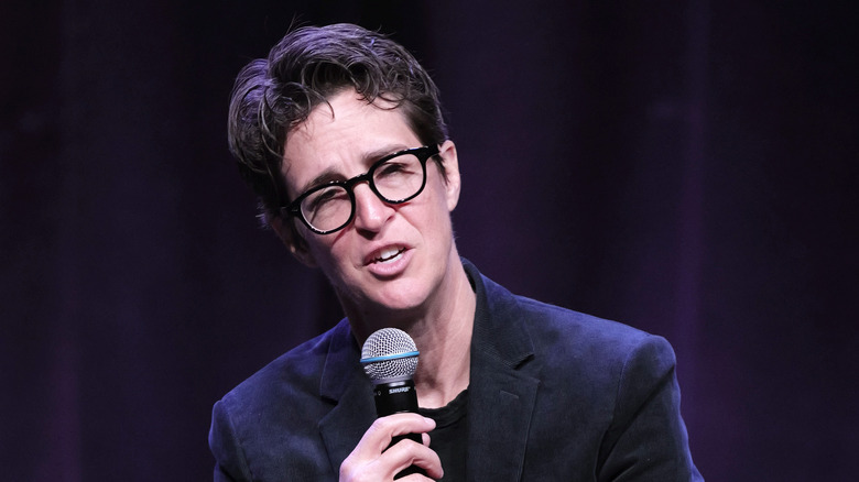 Rachel Maddow speaking into a microphone