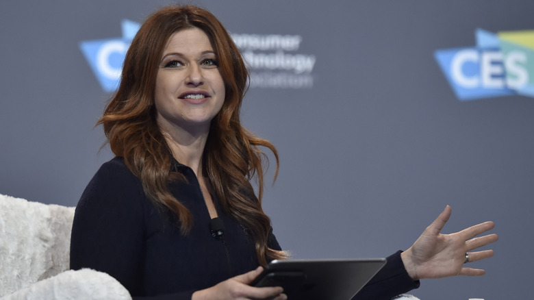 Rachel Nichols speaking while holding tablet