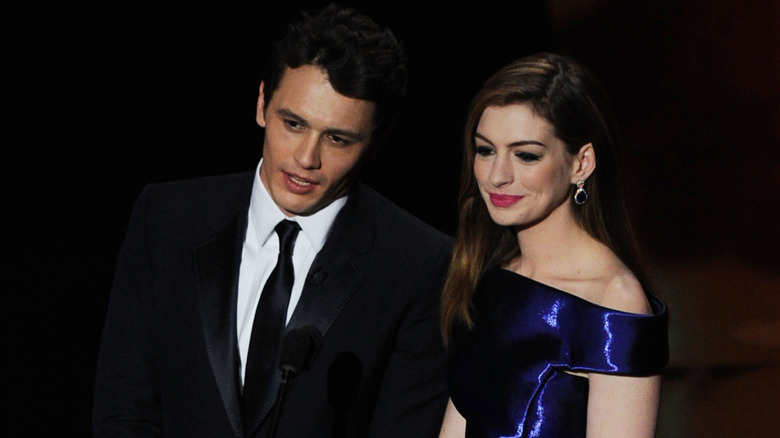 Anne Hathaway in purple gown with James Franco hosting the Oscars