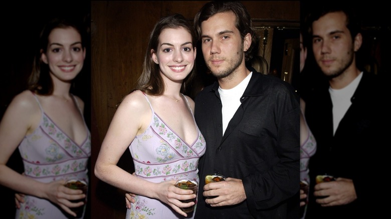 Anne Hathaway and Scott Sartano holding drinks