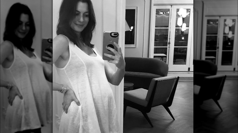 Anne Hathaway, pregnant in black and white photo in white top