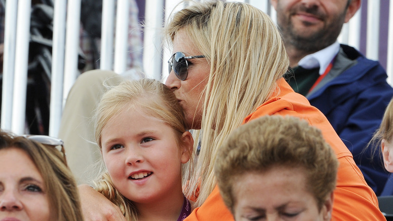 Queen Maxima kisses a young Catharina-Amalia