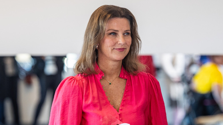 Princess Martha Louise wearing pink and holding flowers