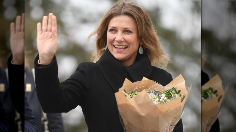 Princess Martha Louise holding a bouquet and waving