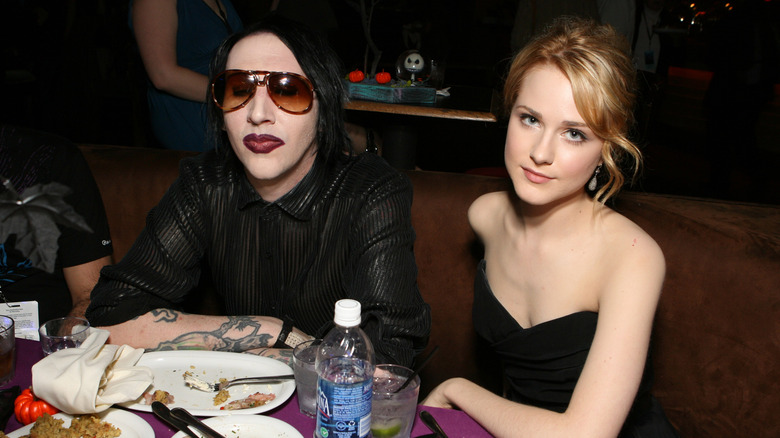 Marilyn Manson and Evan Rachel Wood black sitting in a restaurant booth