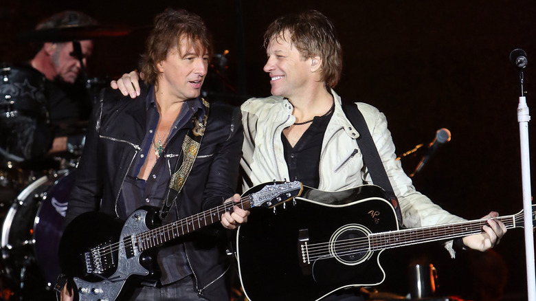 Jon Bon Jovi embraces Richie Sambora onstage 