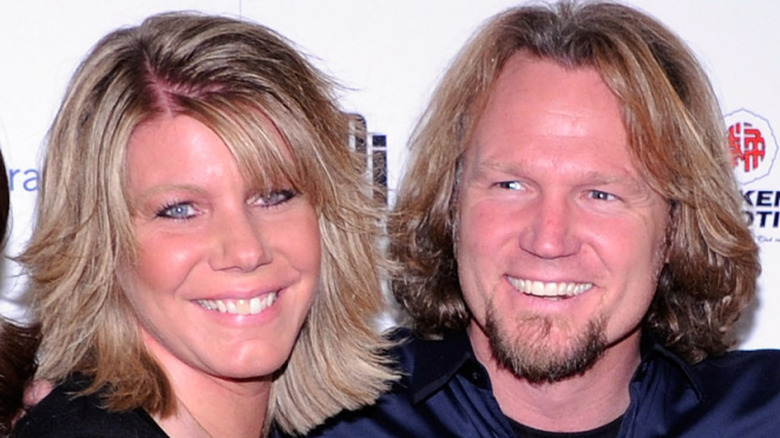 Closeup of Meri Brown smiling with Kody Brown on step-and-repeat