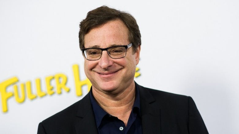 Bob Saget smiling at event.