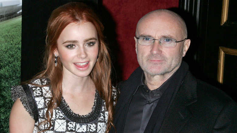 Lily Collins smiling with Phil Collins