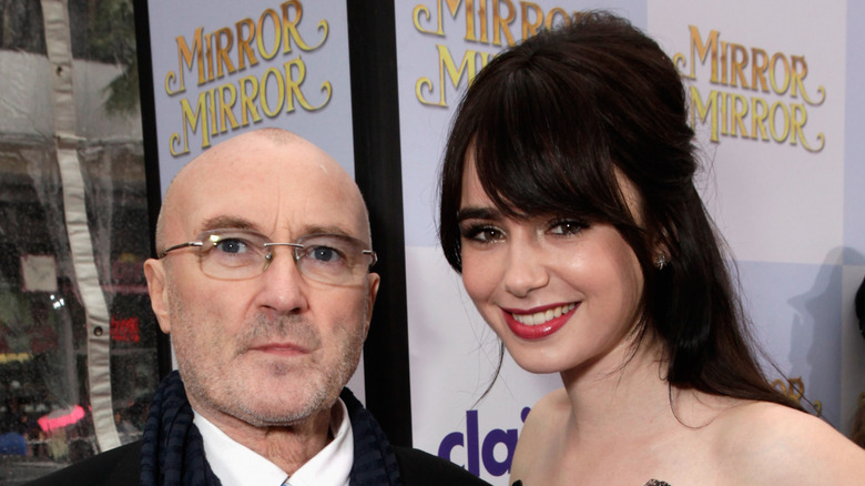 Lily Collins smiling with Phil Collins