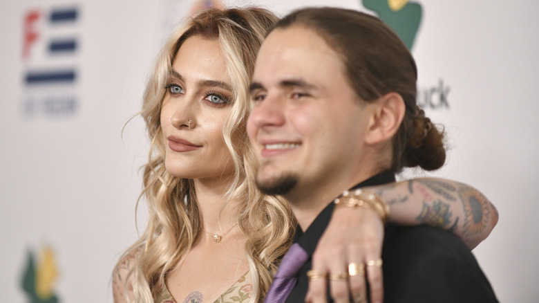 Paris Jackson with her arm around Prince Jackson on step-and-repeat