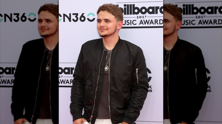 Prince Jackson smiling on step-and-repeat at Billboard 2017 Music Awards