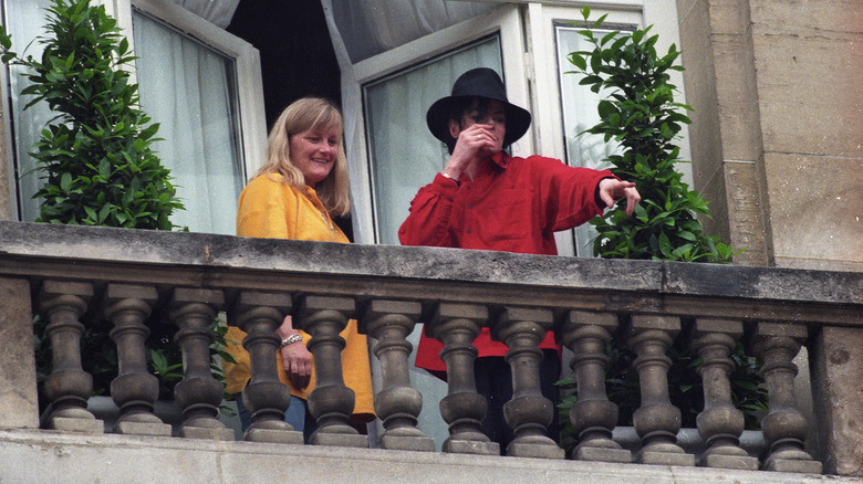 Michael Jackson with Debbie Rowe on balcony