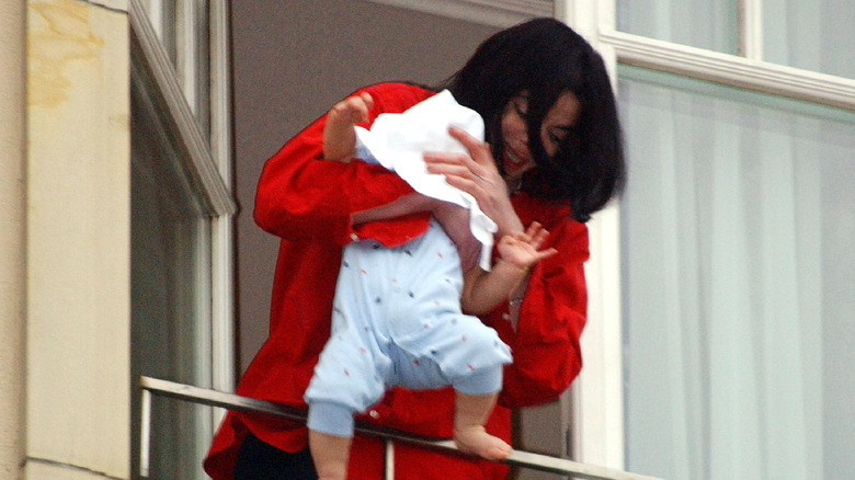 Michael Jackson dangling baby over balcony