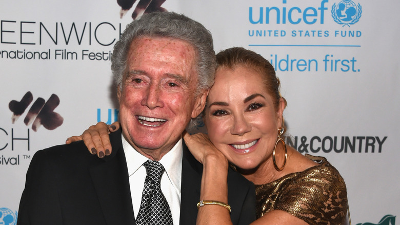 Kathie Lee Gifford embracing Regis Philbin