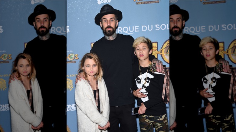 Travis Barker posing with his kids