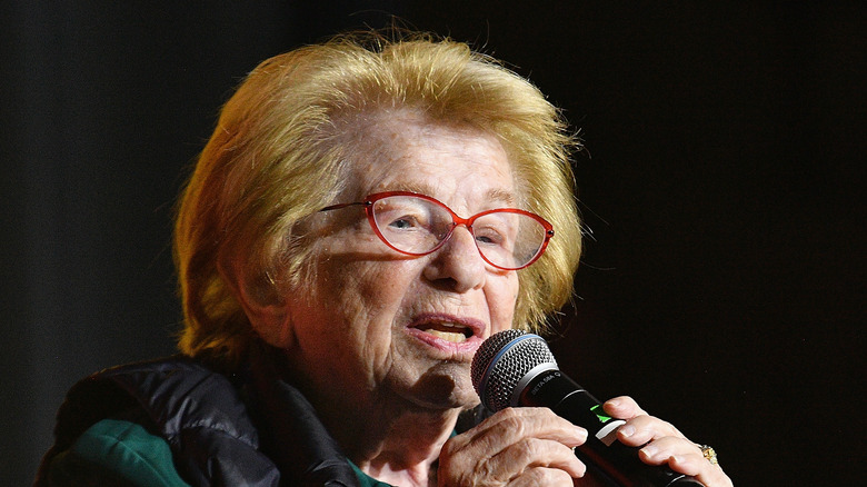 Dr. Ruth onstage with microphone