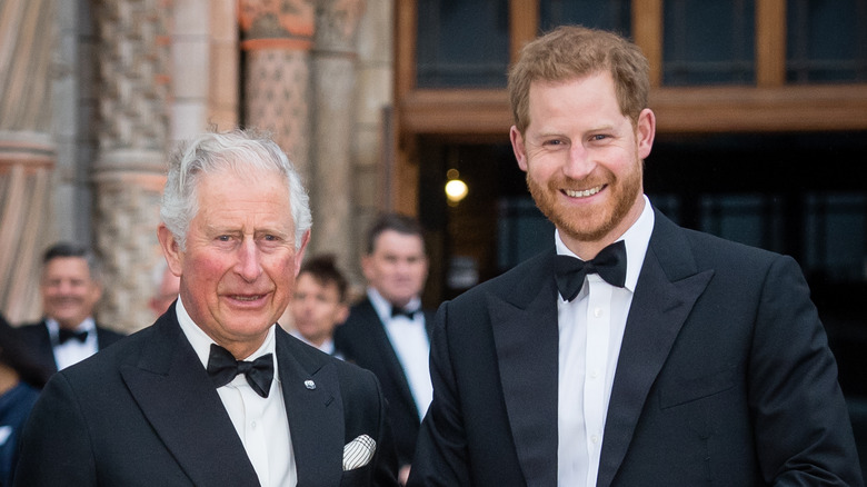 King Charles and Prince Harry smiling