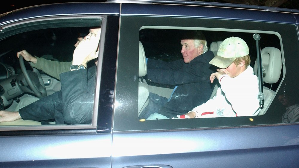 Prince Harry in the backseat of a car avoiding the press