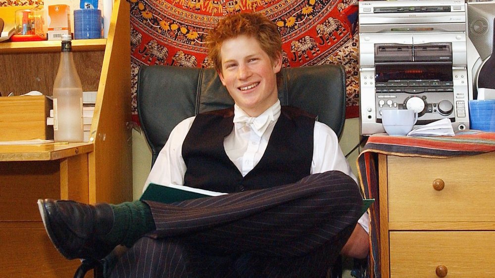 Prince Harry as a teenager smiling and studying