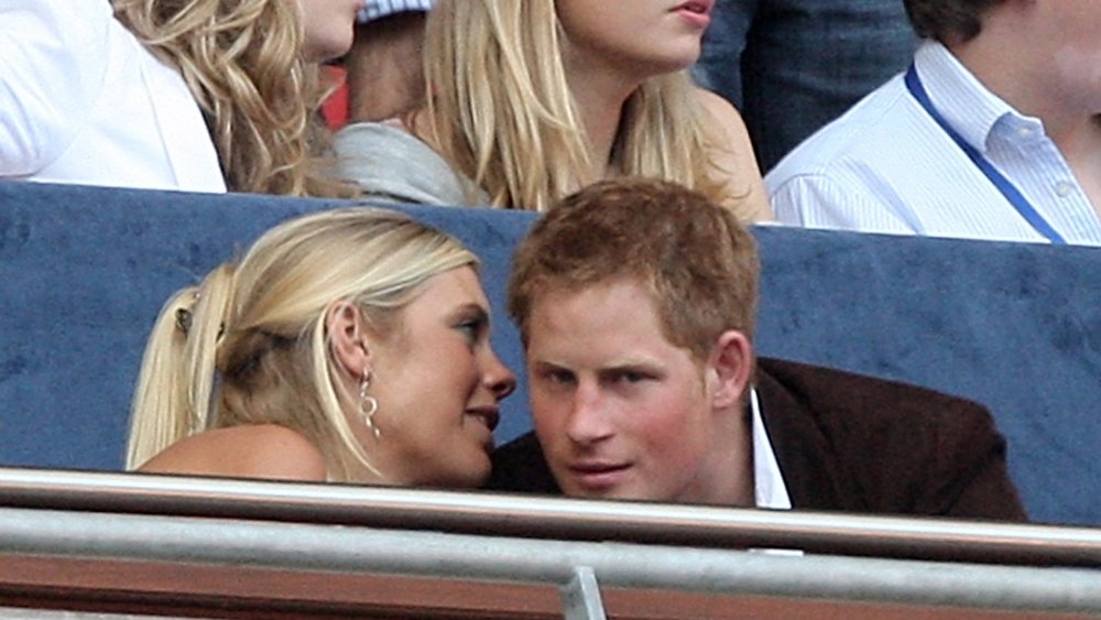 Chelsy Davy whispering something in Prince Harry's ear