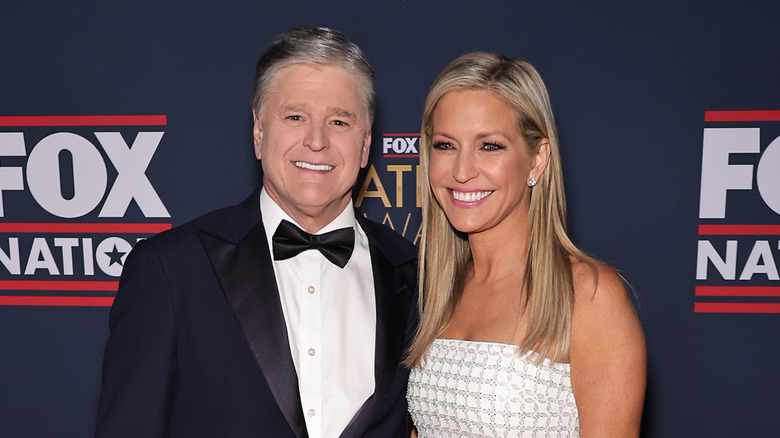 Ainsley Earhardt and Sean Hannity posing at an event