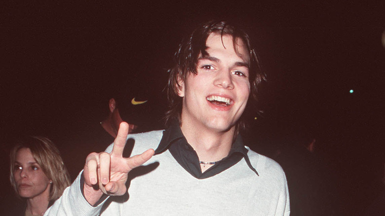 Young Ashton Kutcher making peace sign