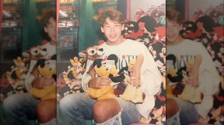 Teenage David Bromstad holding stuffed animals