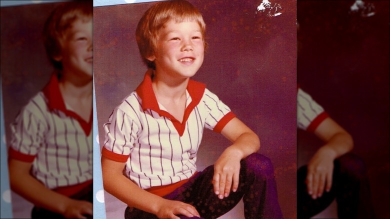 A younger David Bromstad posing, smiling