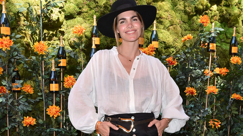 Delfina Blaquier smiling near art installation