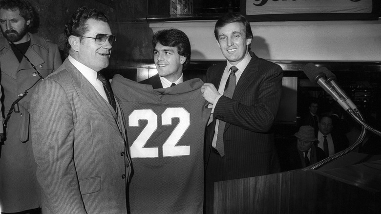 Donald Trump holding a USFL jersey 