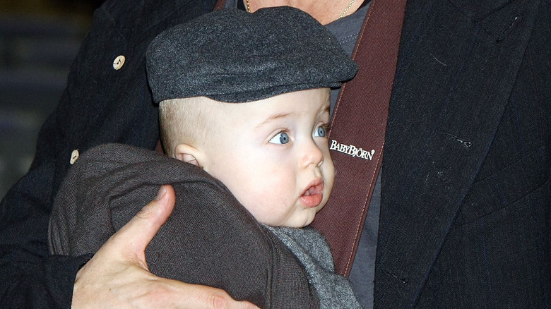 Closeup of Knox Jolie-Pitt as a baby in BabyBjörn carrier worn by Brad Pitt