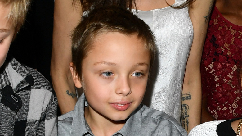 Closeup of young Knox Jolie-Pitt surrounded by crowd