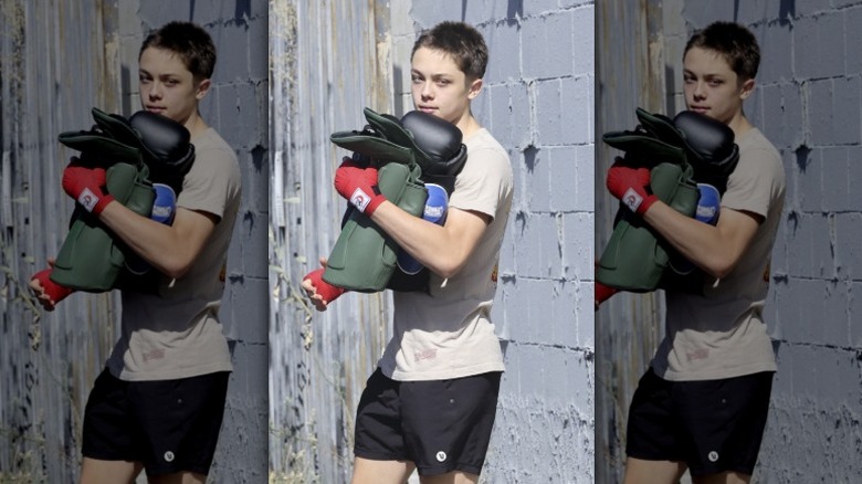 Knox Jolie-Pitt outside carrying boxing gear