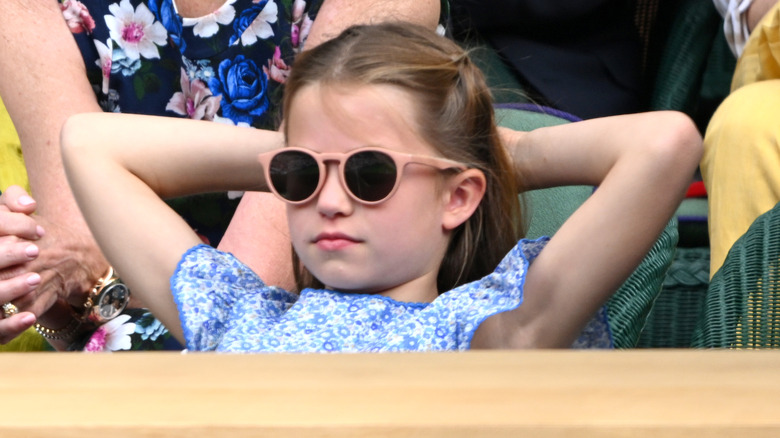 Princess Charlotte sitting back wearing sunglasses 