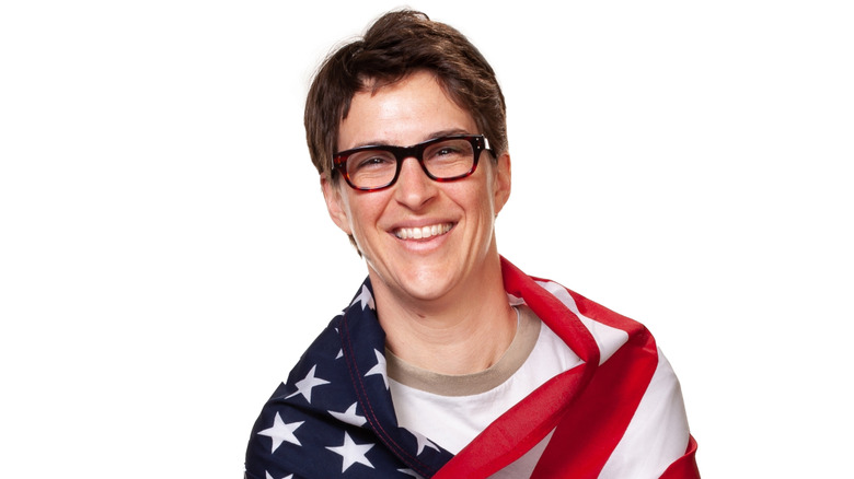 Rachel Maddow wearing an American flag around her shoulders