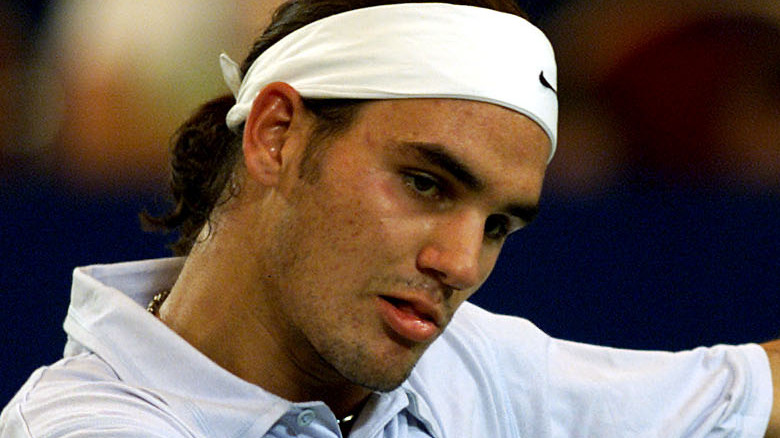 Young Roger Federer playing tennis