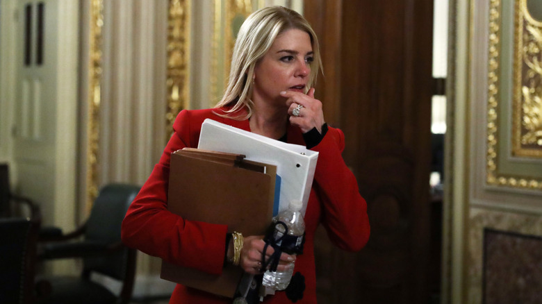 Pam Bondi holds papers at the U.S. Capitol