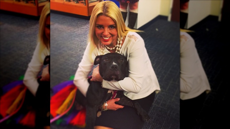 Pam Bondi cuddles a dog