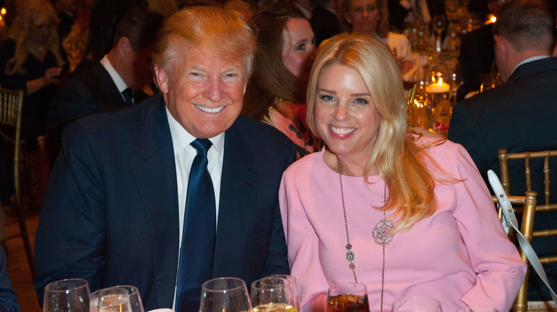 Donald Trump and Pam Bondi smiling at dinner in 2016