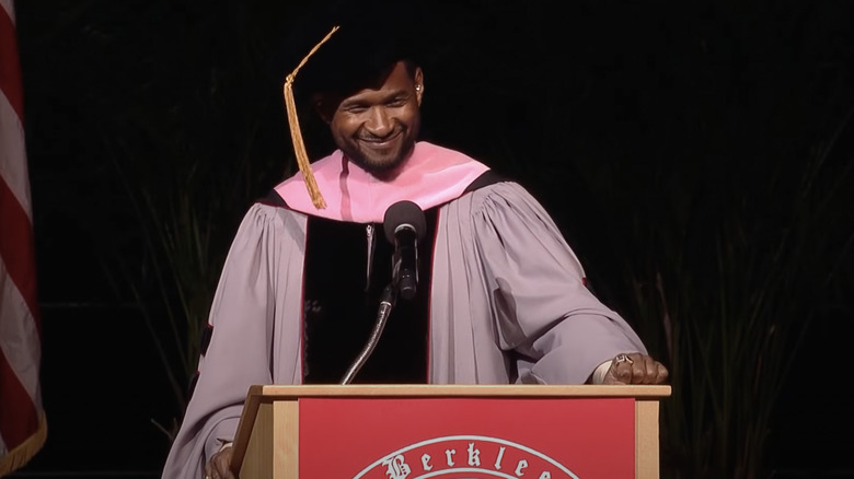 Usher wearing cap and gown 