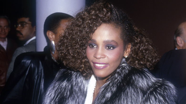 Whitney Houston wearing fur jacket