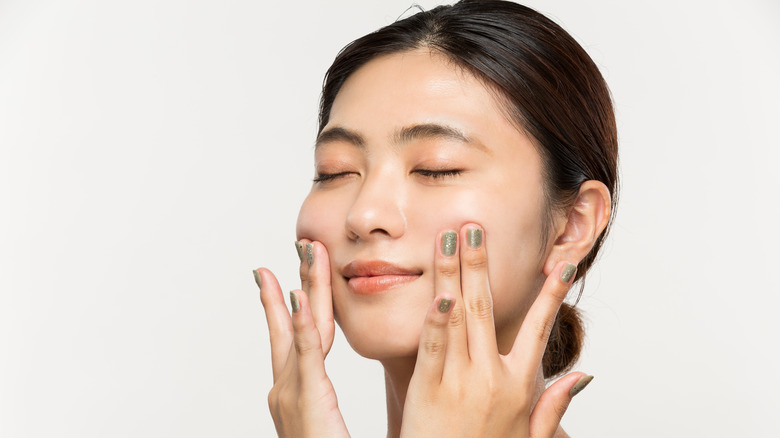 Woman massaging her own face