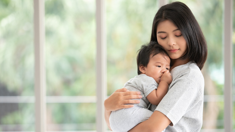 mom holding baby 